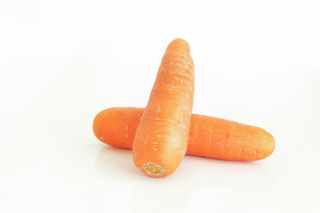 Fresh carrot and cut pieces isolated on white background