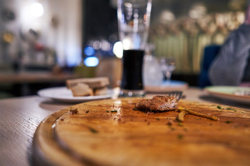 Fototapeta na wymiar leftover meat on a wooden board in a restaurant