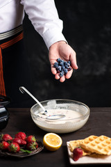 Chef adding fruit in waffles dough