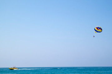 Parasailing - active form of recreation, in which a person is fixed with a long rope to a moving boat and thanks to presence of special parachute hovers through the air