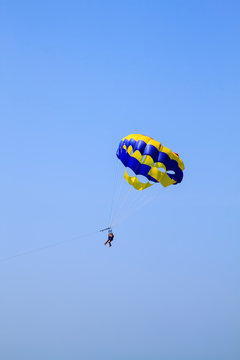 people fly on a parachute, which pulls a boat