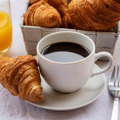 French breakfast, hot cup of coffee with croissants and orange juice. Good morning concept background.