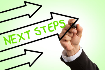 Businessman writing inside arrow