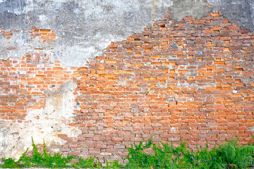 The old building wall that has a slag of cement makes the brick behind.exterior brick walls old buildings decorated with plaster and painted