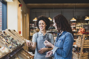 Sales assistant helping customer in a grocery store