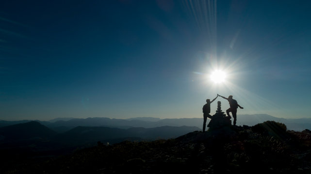 successful people reaching the summit