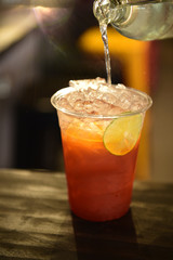 Cold lemon iced tea with fresh sliced lemon in glasses on table