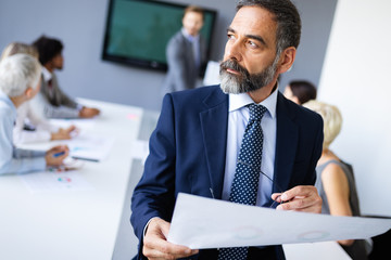 Group of business people collaborating on project in office