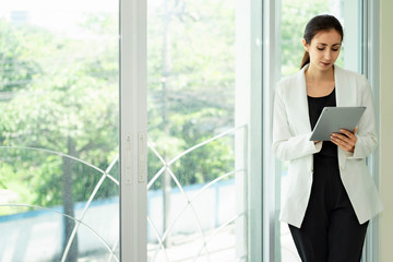 Woman dressed in suits, wearing headphones for receiving phone calls.Customer service by phone