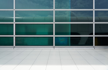 Exterior of a modern glass wall facade building with clean marble floor .