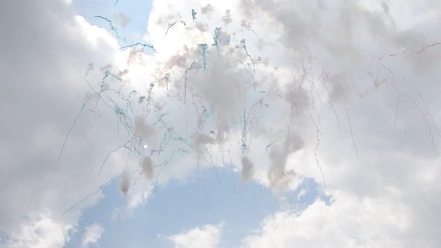 Fireworks with colored smoke exploded during the day