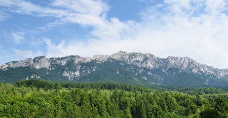 Panoramic view limestone mountain ridge of Piatra Craiului Mountains, view from Plaiul Foii touristic area, Brasov County, Romania
