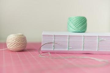 Coptic binding process. Book binding. Thread and pages. Copy space, close up, side view