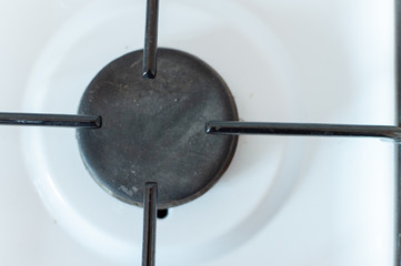 gas burner on the stove, white cooking appliance