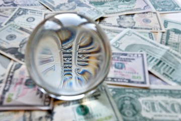 US dollar bill seen through a crystal ball. Creative concept, business, banking, taxes and finance.