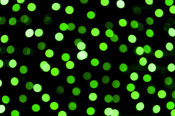 Unfocused abstract colourful bokeh black background. defocused and blurred many round green light