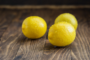 Fresh juicy lemons on the wooden background