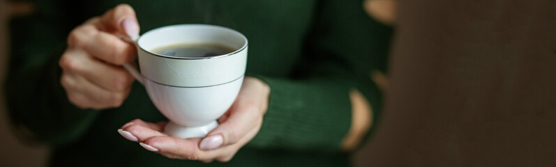 A cup of hot coffee in the hands. Concept drinks, lifestyle, work, background