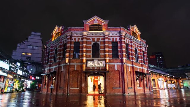time lapse of The Red Chamber Theater or "The Red House Ximen" with falling rain in Ximending district at night in Taipei, Taiwan.