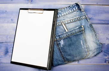 Medical insurance. Paper tablet and pen on jeans background copy space. History of the disease. Medical treatment. Medical help and consultation. Interviewing patient. Psychoanalysis concept