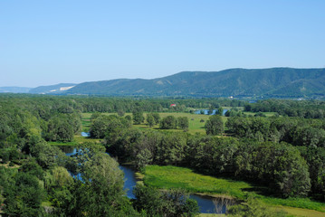 floodplain of the river and mountains on a summer day