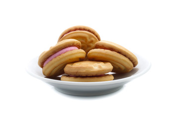 sandwich cookies with strawberry cream on white background