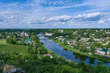 Torzhok, Russia, June 2019.Top view of the summer green city.Visible river, various buildings and above them a blue cloudy sky.