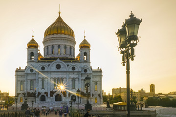 The Cathedral of Christ the Savior, illuminated by the evening sun. The sun's rays penetrate through the building