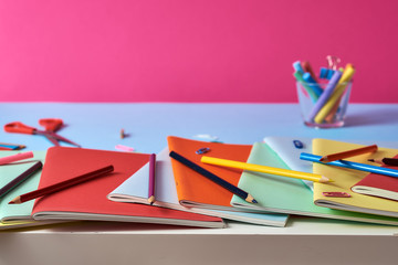  School supplies with notebooks and colored pencils.