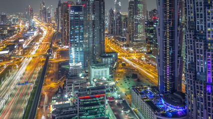 Fototapeta premium Aerial view to traffic on Sheikh Zayed road and skyscrapers on Dubai downtown night timelapse, Dubai, United Arab Emirates