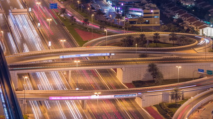Fototapeta na wymiar Night traffic on a busy intersection on Sheikh Zayed road highway aerial timelapse.
