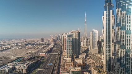 Sunset skyline with modern skyscrapers and traffic on sheikh zayed road timelapse in Dubai, UAE.