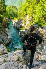 Beautiful girl looking at the Soca river in Lepena, Slovenia