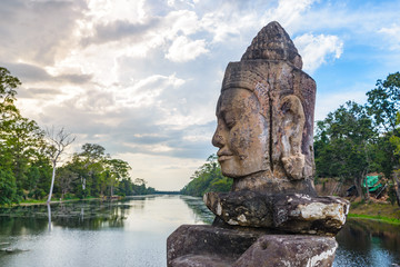 Stone faces in Bayon, Angkor Thom temple, selective focus sunset light. Buddhism meditation concept, world famous travel destination, Cambodia tourism.