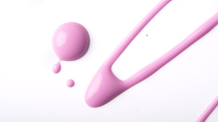 Pink nail polish drips on a white background.