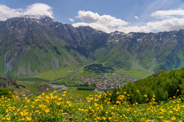 Naklejka na ściany i meble Kazbegi village in summer season, small village surrounded by Caucasus mountain range in Georgia