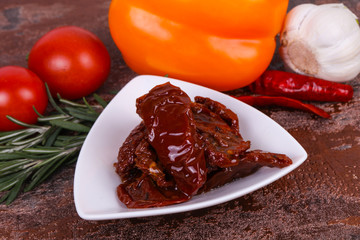 Dried tomatoes in the bowl with olive oil