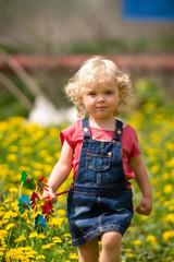 girl walking in a clearing among the flowers