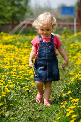 girl walking in a clearing among the flowers