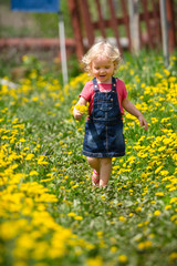 girl walking in a clearing among the flowers