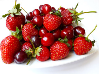fresh strawberries and cherries  on white background