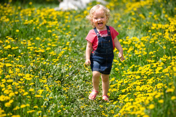 girl walking in a clearing among the flowers