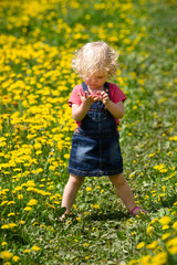 girl walking in a clearing among the flowers