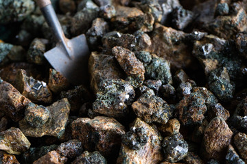 Mining. A miniature shovel and pieces of minerals with crystals.