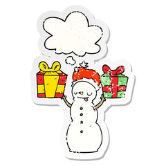 cartoon snowman with present and thought bubble as a distressed worn sticker