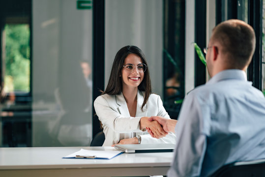 Young businesswoman handshake with a client at modern office.