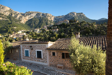 Fototapeta na wymiar Beautiful view of old mountain village Deia in Mallorca on a sunny day. Deia traditional stone village in Majorca Tramuntana mountain