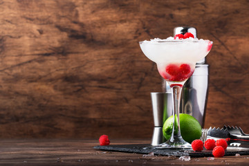 Raspberry daiquiri, alcoholic cocktail with white rum, lime juice, raspberries and crushed ice in...