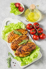 Mexican marinated chicken breasts, grilled with rosemary, vegetables. Top view, space for text.
