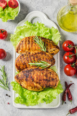Mexican marinated chicken breasts, grilled with rosemary, vegetables. Top view, space for text.